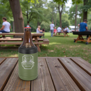 Beer bottle with green sleeve on a wooden table in a park setting