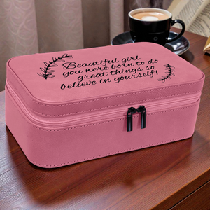 Pink jewelry box with motivational quote on a wooden table with a cup of coffee in the background