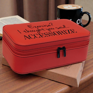 Red accessory case with humorous text on a wooden surface with a coffee cup in the background