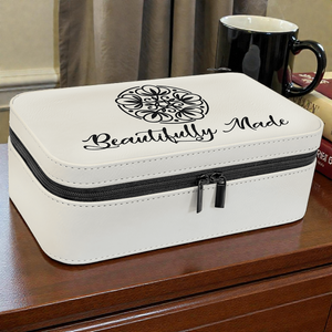 White jewelry box with 'Beautifully Made' logo on a wooden surface