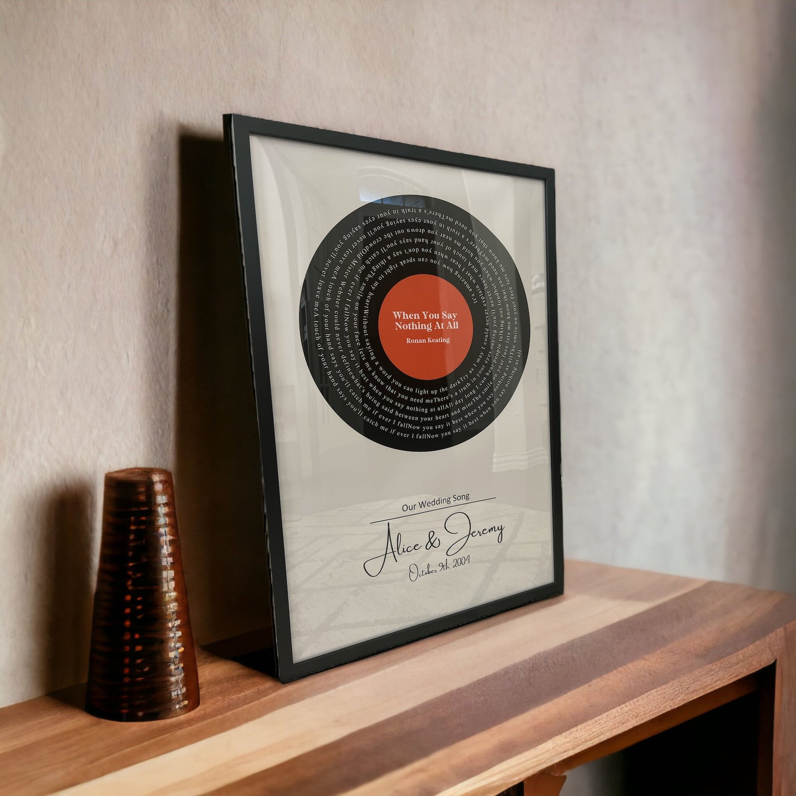 Custom vinyl record lyrics art with personalized names and date in black frame