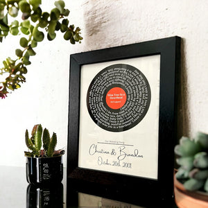 Custom vinyl record lyrics art with personalized names and date in black frame