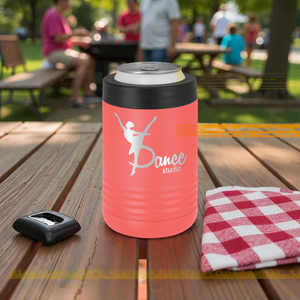 Coral color can cooler with 'Dance Studio' design on a wooden table outdoors.