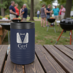Navy blue insulated cup with 'Carl Best Man' text and tuxedo graphic on a wooden table outdoors.