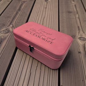 Pink makeup case with text on a wooden surface, custom-engraved by HP Design
