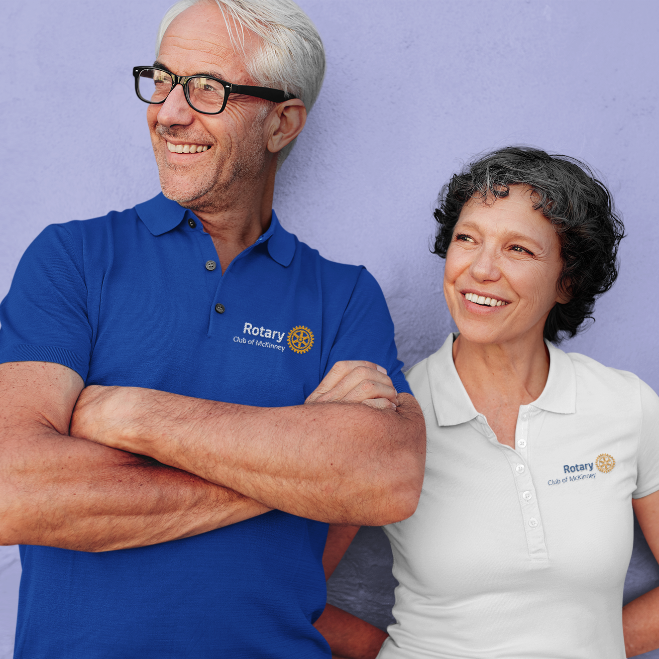 Two people wearing Rotary International shirts against a purple background